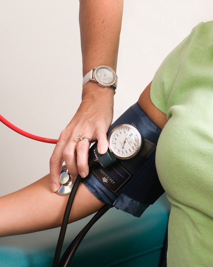 a person with a blood pressure meter on their arm